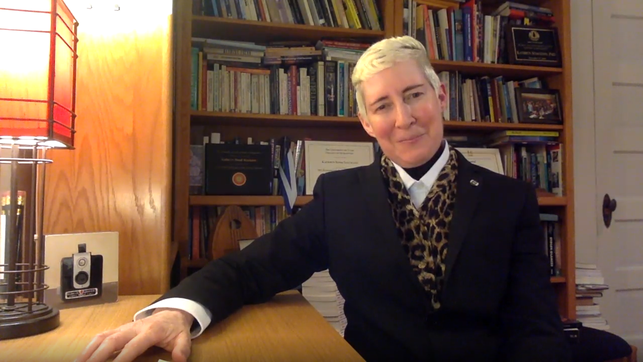 dean stockton sits with her right hand resting on a desk