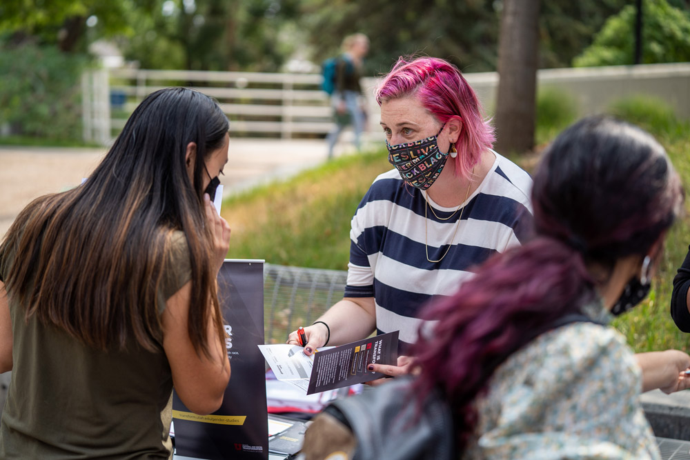 Jen Wozab talks to a student at Welcome Back Bash